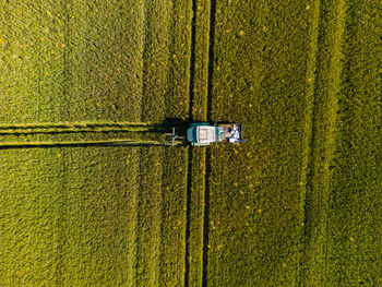 Aerial view of a tractor leaving tracks in a field, germany