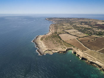 High angle view of bay on shore against sky