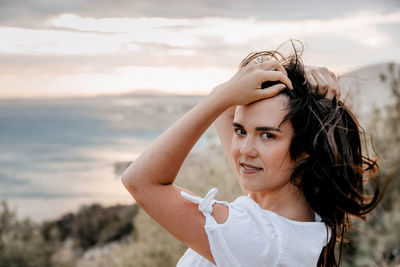 Portrait of beautiful young girl in white summer dress. confident, pretty, hair, hairstyle.