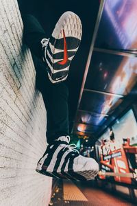 Low section of woman standing on street