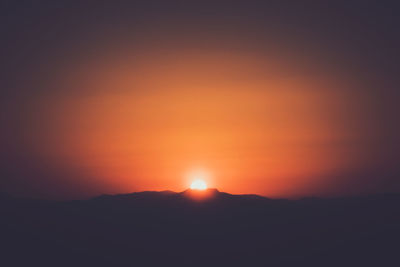 Scenic view of silhouette mountains against sky during sunset