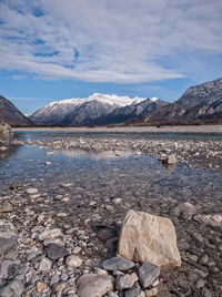 Scenic view of lake and mountains against sky