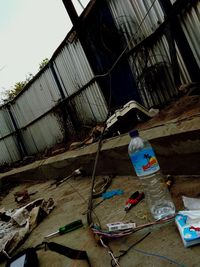 Low angle view of bottle on metal structure