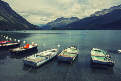 Boats moored on lake against sky