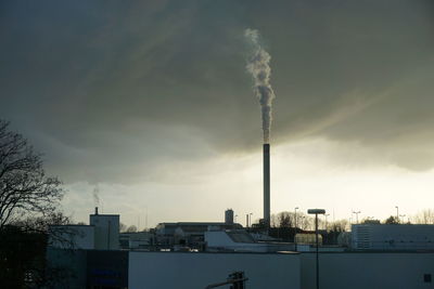 Low angle view of buildings against cloudy sky