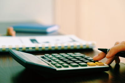 Close-up of person using smart phone on table