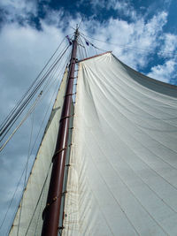 Low angle view of sailboat on bridge against sky