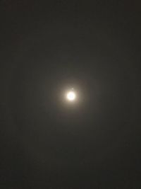 Low angle view of illuminated moon against sky at night