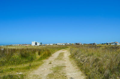 Scenic view of land against clear blue sky