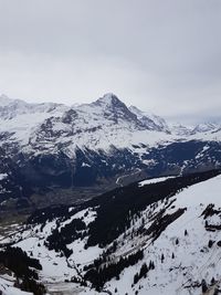 Scenic view of snow covered mountains against sky