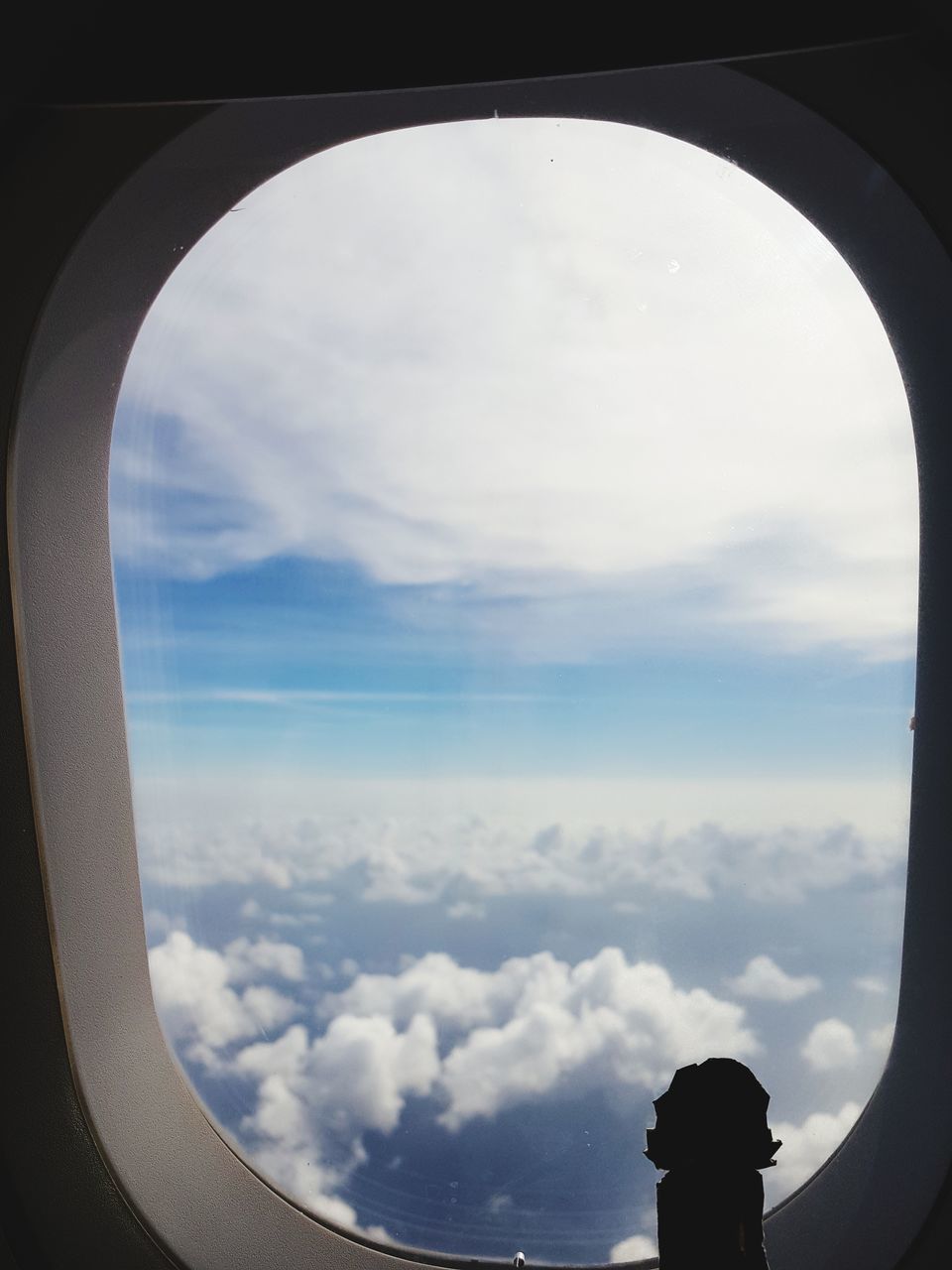 AIRPLANE SEEN THROUGH GLASS WINDOW