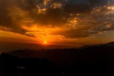 Scenic view of silhouette mountains against sky during sunset