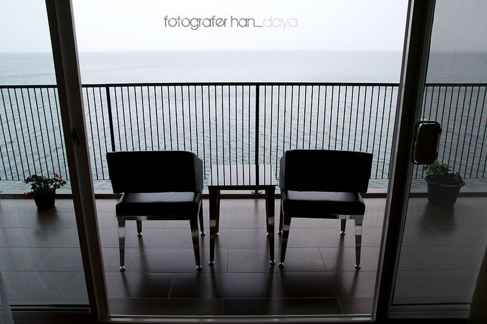 sea, water, horizon over water, chair, empty, railing, indoors, window, absence, beach, sky, seat, day, transparent, in a row, glass - material, sunlight, reflection, no people, table