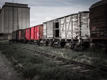 Abandoned train on railroad track in city