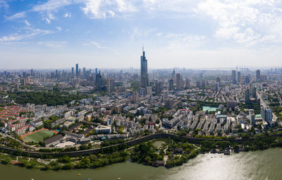 Aerial view of buildings in city against sky