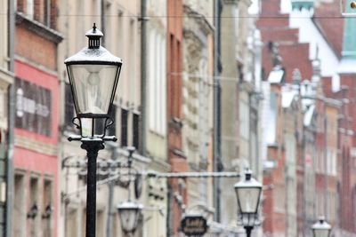 Close-up of street light against building