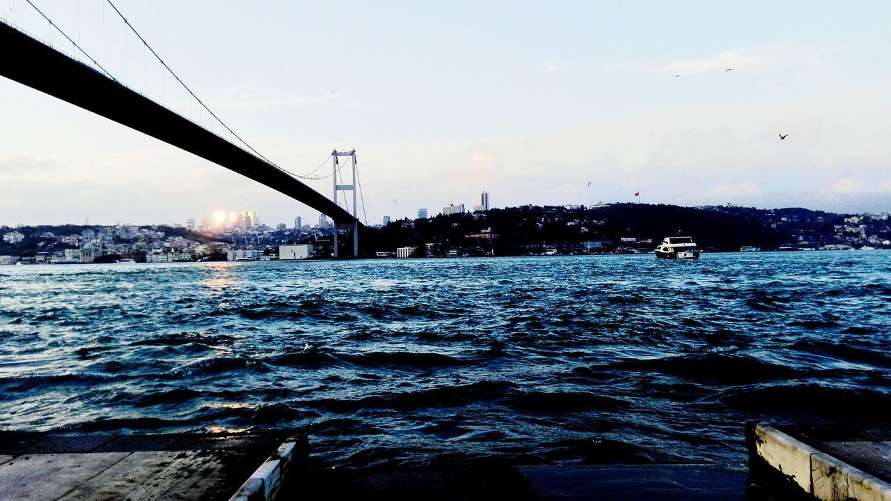 BRIDGE BY SEA AGAINST SKY