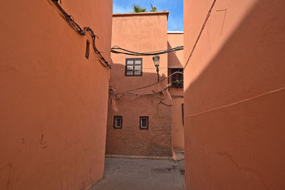 Red colored houses in marrakesh and an alley