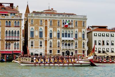 Group of people in boat against building