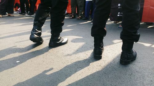 Low section of man walking on street