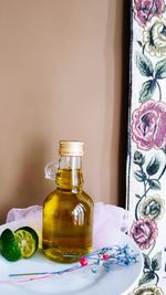 Close-up of wine glass on table against wall