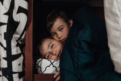 Portrait of cute boys with relaxing on bed