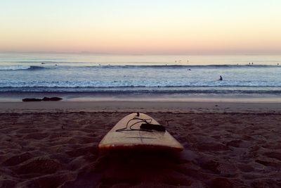 Scenic view of beach against sky during sunset