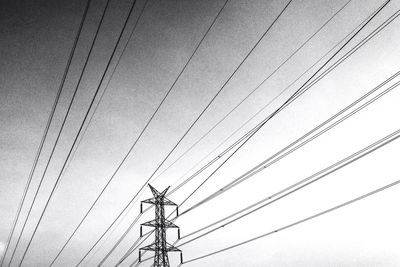 Low angle view of electricity pylon against sky