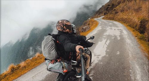 Man riding bicycle on road