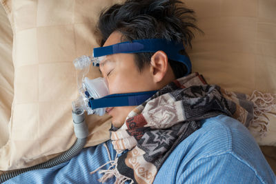 Close-up of boy on bed