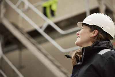 Female engineer standing at building site