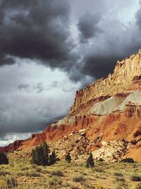 View of rocky mountain against cloudy sky