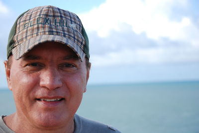 Portrait of smiling mid adult man against sea