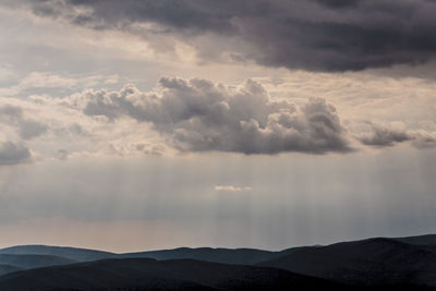 Scenic view of mountains against dramatic sky