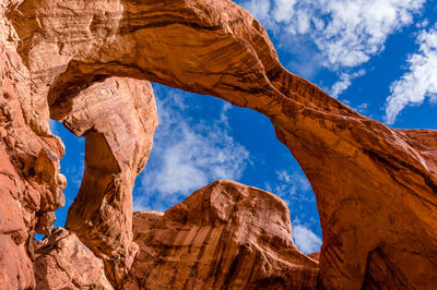 Low angle view of rock formations against blue sky