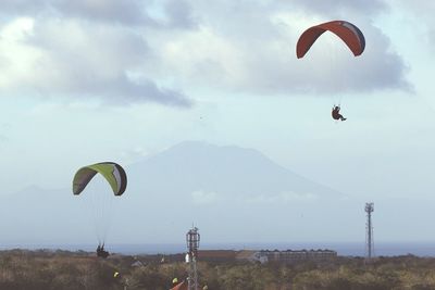 Person paragliding against sky