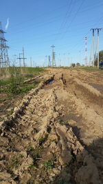 Electricity pylon on field against sky