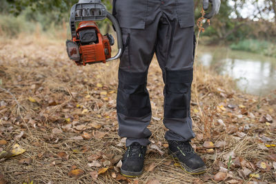 Low section of man standing on field