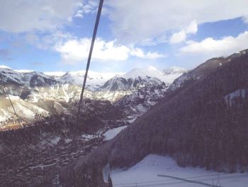 Scenic view of snow covered mountains against sky