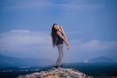 Woman standing against sky