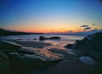 Scenic view of sea against clear sky during sunset