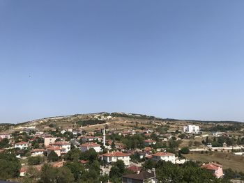 Townscape against clear blue sky