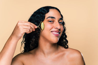 Portrait of young woman against white background