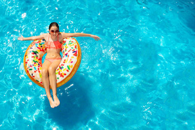 High angle view of woman swimming in sea