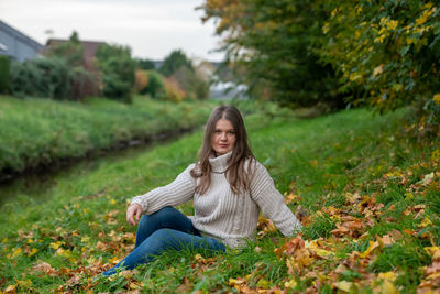 Portrait of woman sitting on field