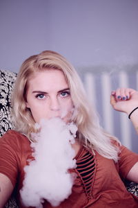 Close-up portrait of young woman at home