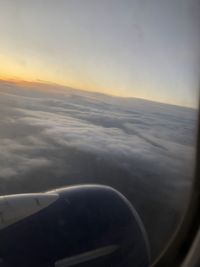 Aerial view of clouds seen through airplane window