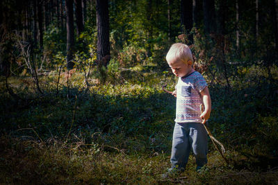 Full length of man standing in forest