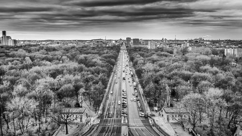 High angle view of road amidst trees against sky