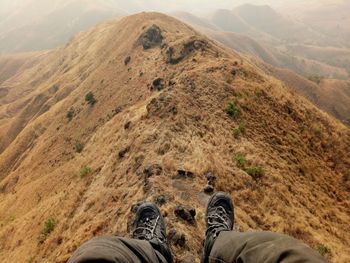 Low section of man sitting on mountain